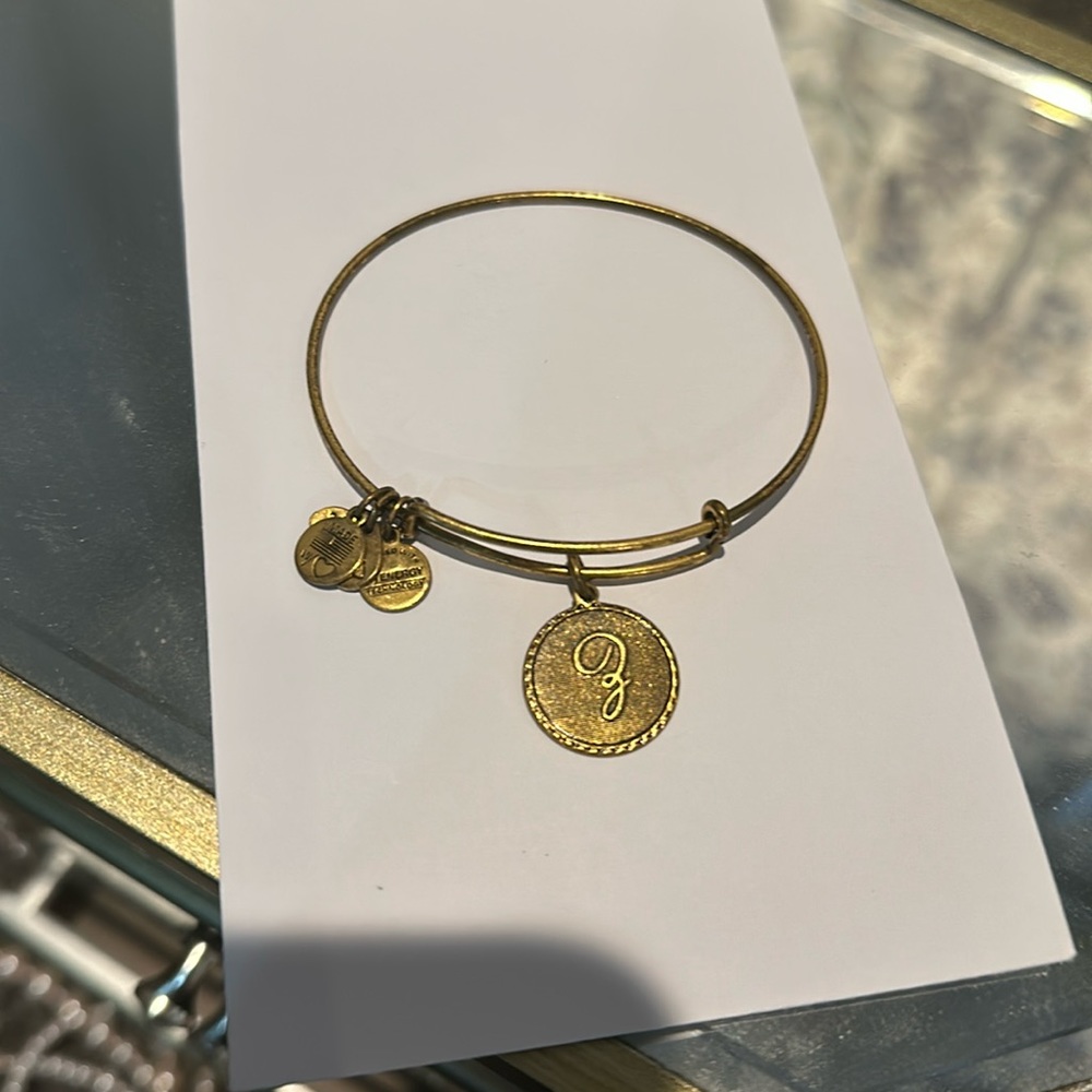 Women’s gold Alex and Ani charm bracelet with Letter Pendant and detailed border